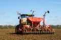 Back view of Modern John Deere tractor drilling seed in field Royalty Free Stock Photo