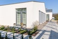 Back view of suburban house with trendy backyard with concrete path