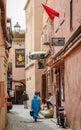 Back view of a Moroccan woman walking at a narrow alley in Marrakesh medina