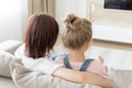 Back view of Mother and daughter sitting on sofa at their home and watching tv, Family time concept Royalty Free Stock Photo