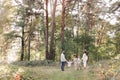 Back view of mother, father with three kids are walking, having fun in autumn forest. Family holding children hands Royalty Free Stock Photo