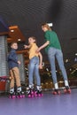 back view of mother and kids skating together
