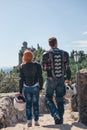 Back view motorcyclists couple. Dressed in a motorbike outfit and sunglasses. body protection turtle and knee pads, holding