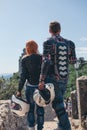 Back view motorcyclists couple. Dressed in a motorbike outfit and sunglasses. body protection turtle and knee pads, holding