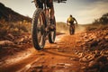 Back view Mountain bikes tire and riders foot on brown dirt path