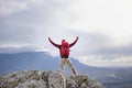 Back view, mountain and man with celebration for hiking, peak and journey with success and freedom outdoor. Trekking Royalty Free Stock Photo