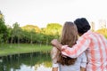 Back view of multi ethnic couple in love while looking at peacef Royalty Free Stock Photo