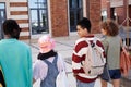 Back view of multiethnic group of students walking together on college campus Royalty Free Stock Photo