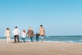 back view of multigenerational family walking on beach Royalty Free Stock Photo