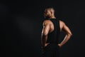 back view of muscular young african american man standing with hands on waist and looking away Royalty Free Stock Photo