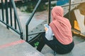 Back view of Muslim woman relax and admire the beautiful scenery in the evening on The Bridge of the River Kwai in Kanchanaburi,