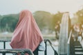 Back view of Muslim woman relax and admire the beautiful scenery in the evening on The Bridge of the River Kwai in Kanchanaburi,