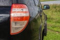 Back view of new black car. Closeup headlights of car. Black premium city crossover, luxury SUV rear light closeup. Car Royalty Free Stock Photo