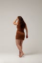 Plus size fashion model in brown short dress