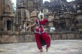 Back view of an odissi dancer posing at Mukteshvara Temple, Bhubaneswar, Odisha, India