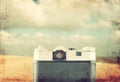 Back view of old camera in front sea. vintage filtered image. Royalty Free Stock Photo