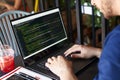 Developer programmer with laptop. Program code and script data on screen. Young freelancer in glasses working on project Royalty Free Stock Photo