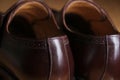 Back view of a pair of classic brown leather Brogue shoes