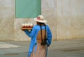 Back view of a Peruvian lady selling jelly sweets at the main square of Puno, Peru