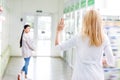 back view of pharmacist waving hand to pregnant woman Royalty Free Stock Photo