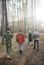 Back view photo of group of friends walking outdoors Royalty Free Stock Photo