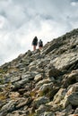 Back view photo of hikers climbing a slope of a mountain in the French Riviera