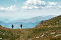 Back view photo of hikers standing at the edge of a hill in the French Riviera backcountry