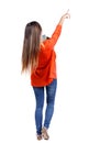 Back view pointing woman with a stack of books. Royalty Free Stock Photo