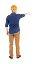 Back view of pointing young men in shirt and helmet. Royalty Free Stock Photo