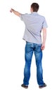 Back view of pointing young men in shirt and jeans Royalty Free Stock Photo