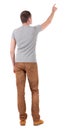 Back view of pointing young men in shirt and jeans Royalty Free Stock Photo