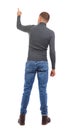 Back view of pointing young men in shirt and jeans. Royalty Free Stock Photo