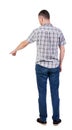 Back view of pointing young men in shirt and jeans. Royalty Free Stock Photo