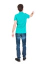 Back view of pointing young men in shirt and jeans. Royalty Free Stock Photo