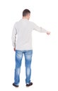 Back view of pointing young men in shirt and jeans. Royalty Free Stock Photo