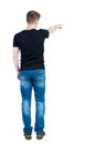 Back view of pointing young men in shirt and jeans. Young guy Royalty Free Stock Photo