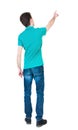 Back view of pointing young men in shirt and jeans. Young guy Royalty Free Stock Photo