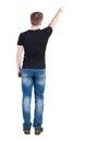 Back view of pointing young men in t-shirt and jeans. Royalty Free Stock Photo