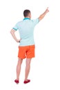 Back view of pointing young men in t-shirt and shorts.