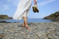 Back view of woman legs walking on the beach Royalty Free Stock Photo