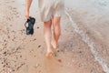 Woman walking on the beach leaving footprints in the sand Royalty Free Stock Photo