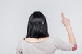 Back view portrait of a brunete girl pointing finger up Royalty Free Stock Photo