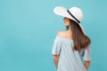 Back view portrait of elegant fashion young woman in white summer large wide brim sun hat, dress put hands on head Royalty Free Stock Photo