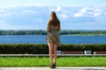 Back view portrait in full growth, young beautiful brunette woman in a green dress Royalty Free Stock Photo