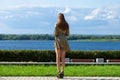 Back view portrait in full growth, young beautiful brunette woman in a green dress Royalty Free Stock Photo