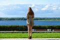 Back view portrait in full growth, young beautiful brunette woman in a green dress Royalty Free Stock Photo