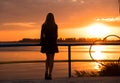 Portrait of happy girl silhouette contemplating sun at sunset on beach Royalty Free Stock Photo