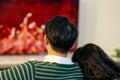 Back view portrait of lover couple in love in Christmas eve holiday lyting on the couch enjoy watching a movie and series on Royalty Free Stock Photo