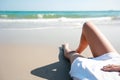 Back view portrait of sexy young girl legs lying on sandy tropical beach in nature with blue sky Royalty Free Stock Photo