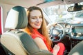 Back view Portrait of smiling business lady, caucasian young woman driver looking at camera and smiling over her shoulder while Royalty Free Stock Photo